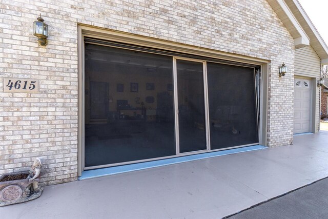 doorway to property featuring brick siding