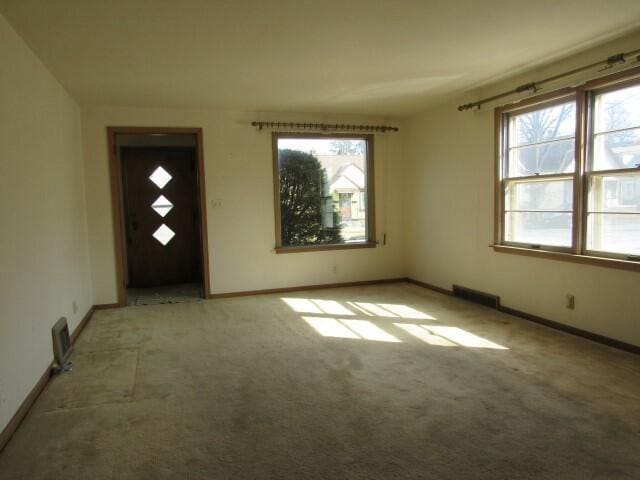 interior space with visible vents, baseboards, and carpet floors