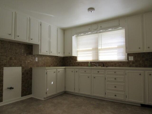 kitchen with white cabinets and backsplash