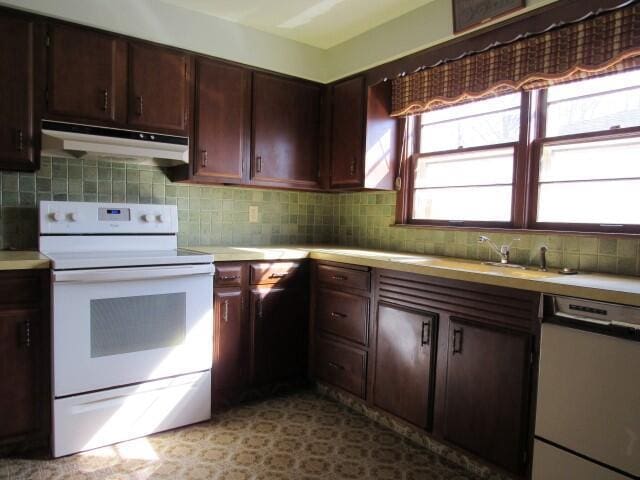 kitchen featuring white electric stove, light countertops, under cabinet range hood, dishwasher, and backsplash