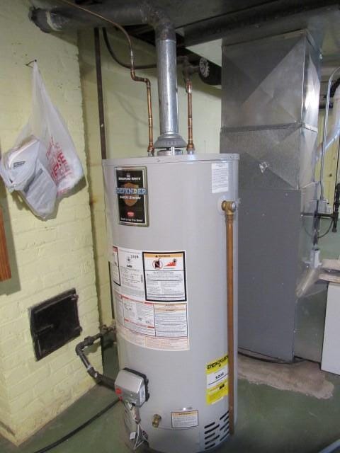 utility room featuring gas water heater and heating unit