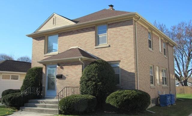 exterior space featuring cooling unit and brick siding