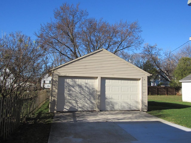 detached garage featuring fence