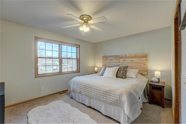 carpeted bedroom featuring visible vents, baseboards, and ceiling fan