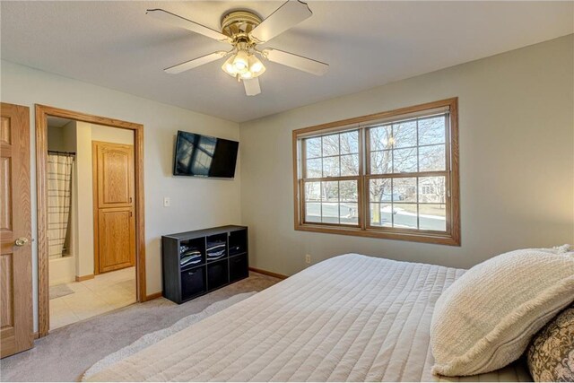 bedroom with light colored carpet, baseboards, and ceiling fan