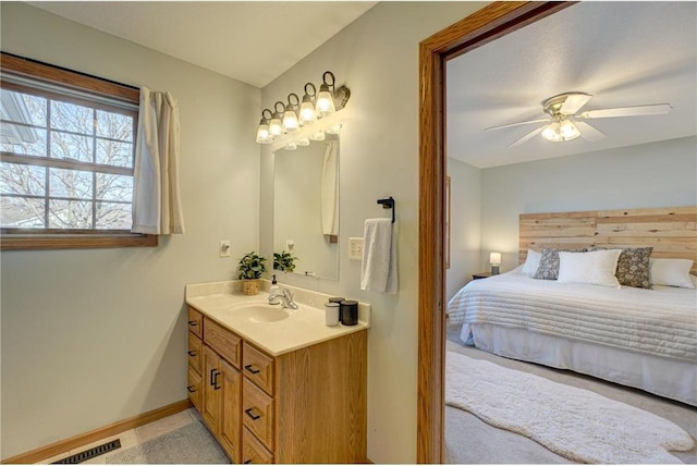 bathroom featuring visible vents, baseboards, ceiling fan, and vanity