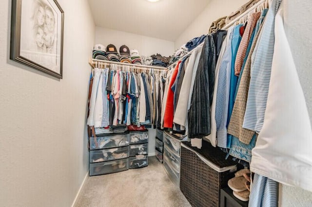 walk in closet featuring carpet