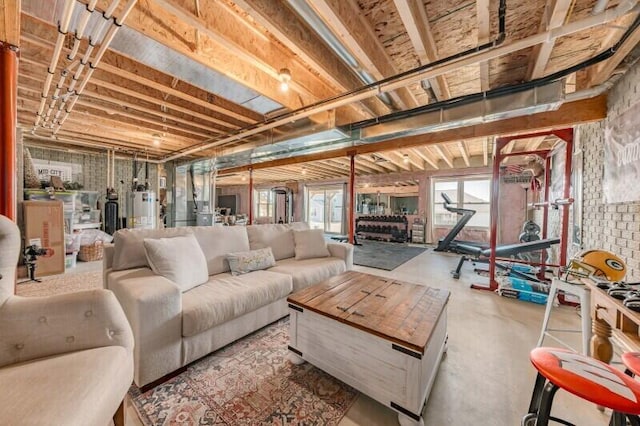 living area with water heater and concrete flooring