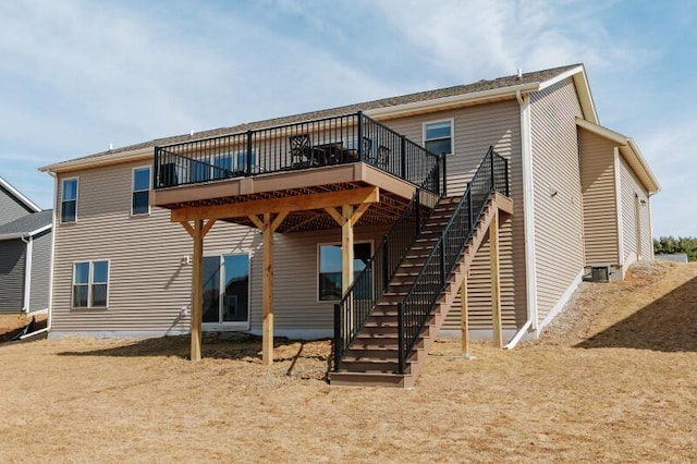 back of property featuring cooling unit, a wooden deck, and stairs