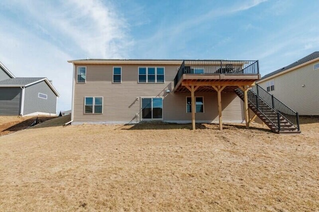 back of house featuring stairway and a wooden deck