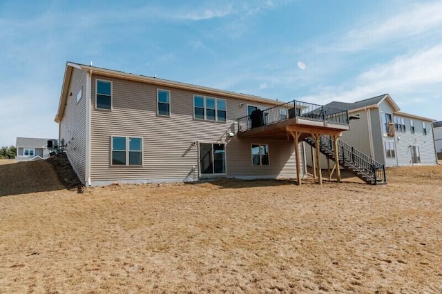 back of property featuring stairs and a deck