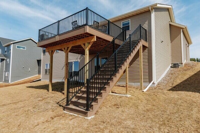 rear view of house with a deck and stairs