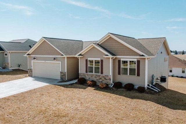 craftsman inspired home featuring concrete driveway, roof with shingles, central AC unit, a garage, and stone siding