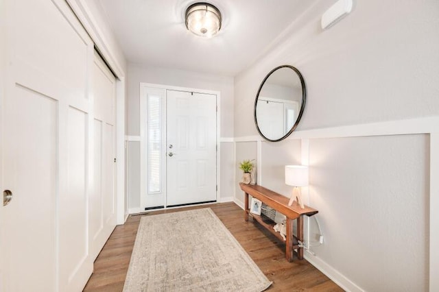 foyer with baseboards and light wood-style floors