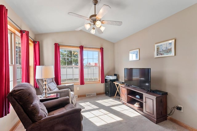 sitting room with lofted ceiling, baseboards, visible vents, and ceiling fan