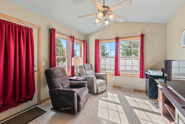 living area with visible vents, baseboards, ceiling fan, and vaulted ceiling