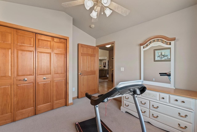 exercise room featuring light colored carpet, a ceiling fan, and vaulted ceiling