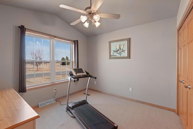 workout area with light carpet, visible vents, baseboards, and vaulted ceiling