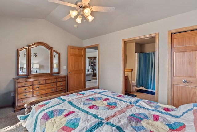 carpeted bedroom with lofted ceiling, a ceiling fan, and connected bathroom