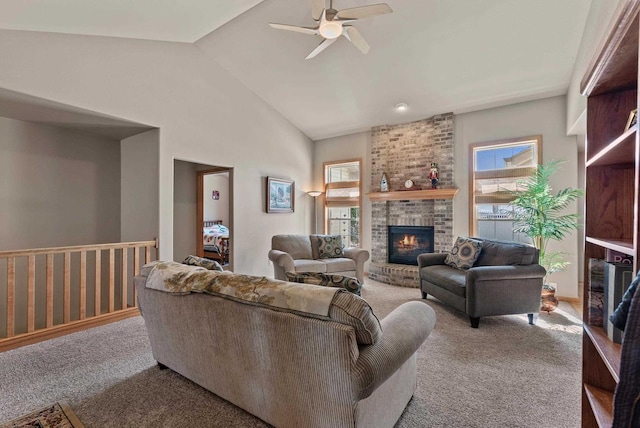 living room featuring lofted ceiling, a brick fireplace, carpet floors, and ceiling fan