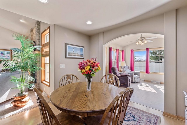 dining area with baseboards, visible vents, recessed lighting, arched walkways, and ceiling fan