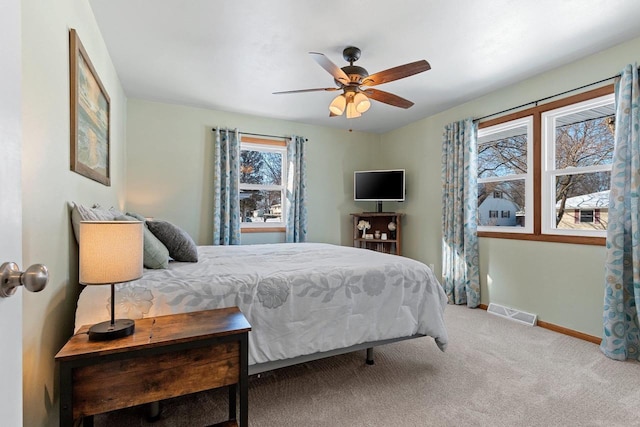 bedroom with visible vents, baseboards, carpet, and ceiling fan