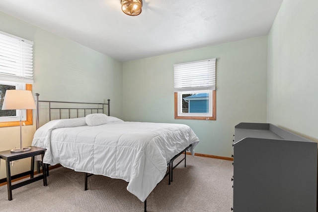 carpeted bedroom with baseboards