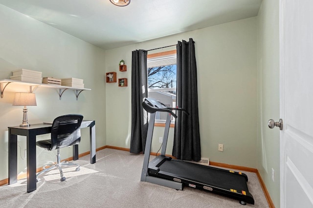 workout room featuring baseboards and carpet flooring