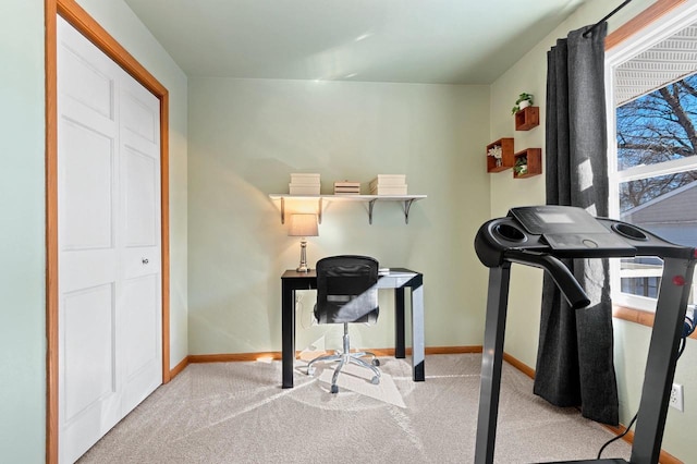 carpeted office featuring baseboards