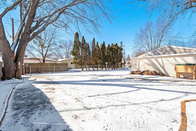 yard layered in snow featuring fence