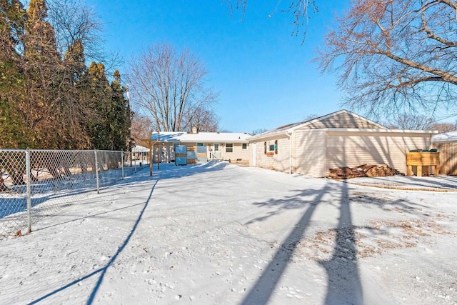 snow covered house featuring fence