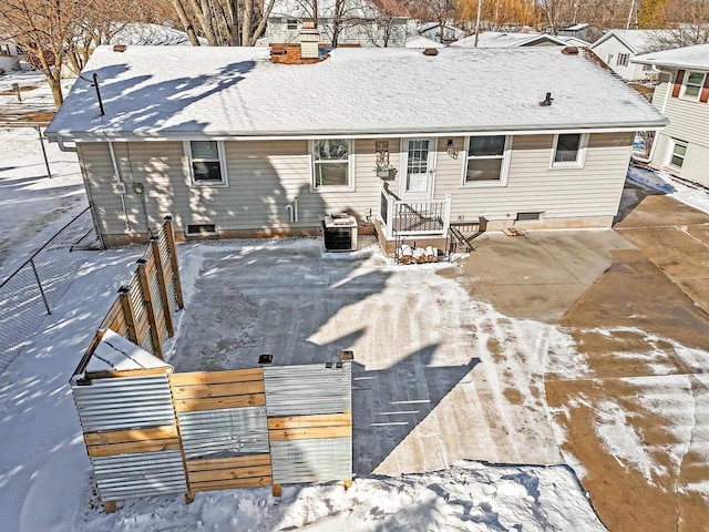 snow covered property featuring central air condition unit