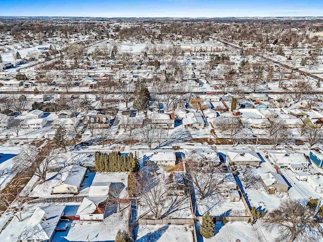 snowy aerial view with a residential view