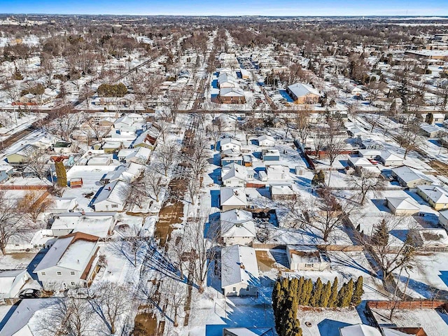 snowy aerial view featuring a residential view