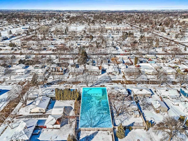 snowy aerial view featuring a residential view