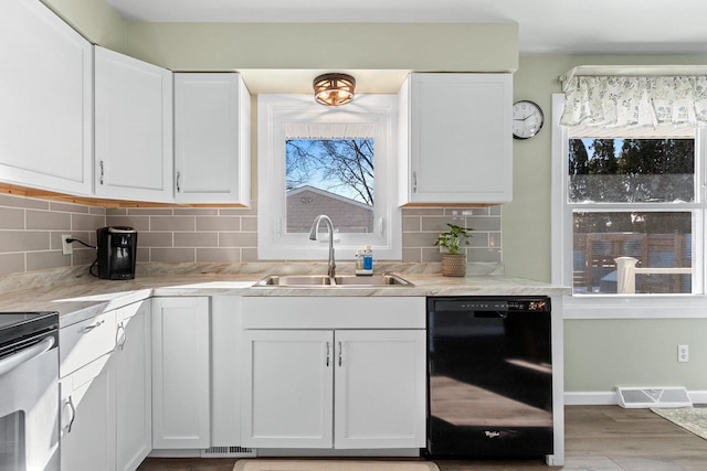 kitchen featuring white cabinetry, black dishwasher, backsplash, and a sink