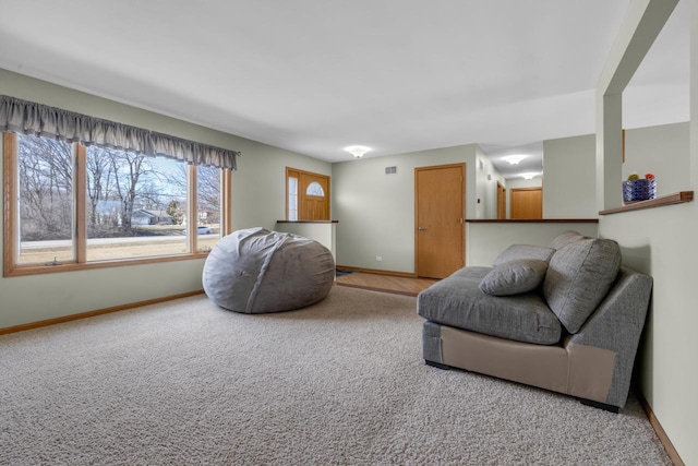 living room featuring carpet flooring, visible vents, and baseboards