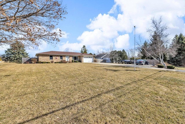 view of yard with a garage and driveway