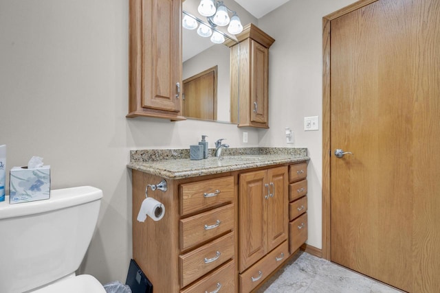 half bathroom with vanity and toilet