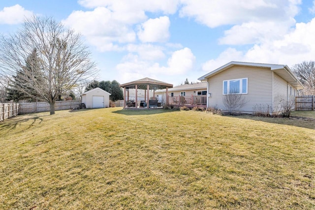 view of yard with a gazebo, a storage unit, an outbuilding, and a fenced backyard