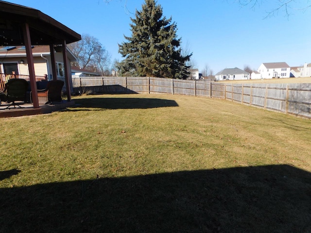 view of yard with a residential view and a fenced backyard