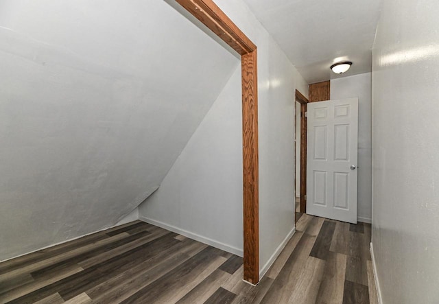 staircase featuring baseboards and wood finished floors