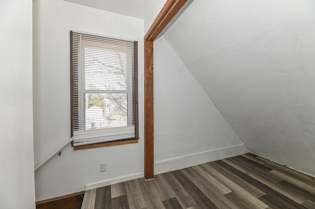 spare room featuring baseboards and dark wood-style flooring