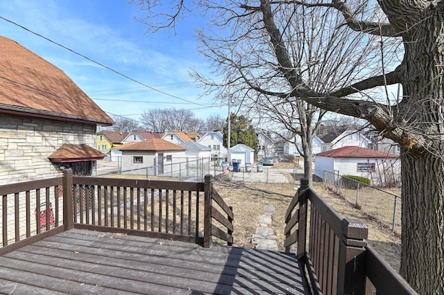 wooden deck featuring a residential view and fence