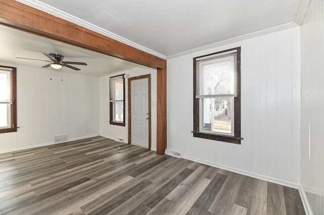 unfurnished room with visible vents, baseboards, a ceiling fan, and wood finished floors