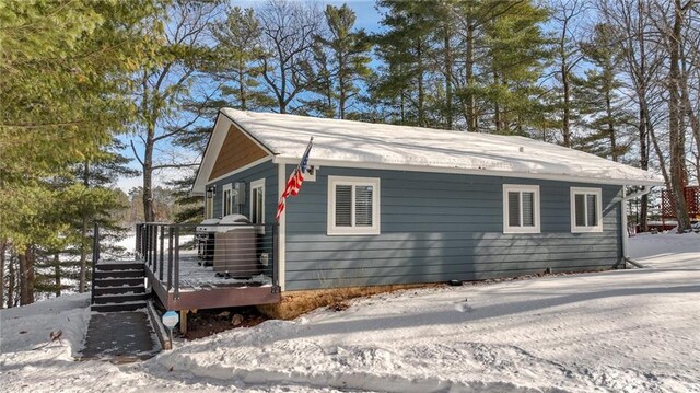 snow covered property featuring a deck