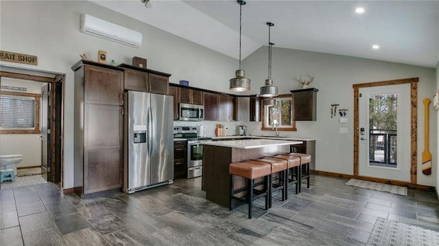 kitchen featuring dark brown cabinets, a kitchen island, light countertops, appliances with stainless steel finishes, and a wall mounted AC