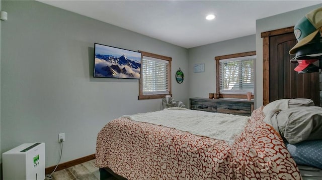 bedroom featuring baseboards and wood finished floors