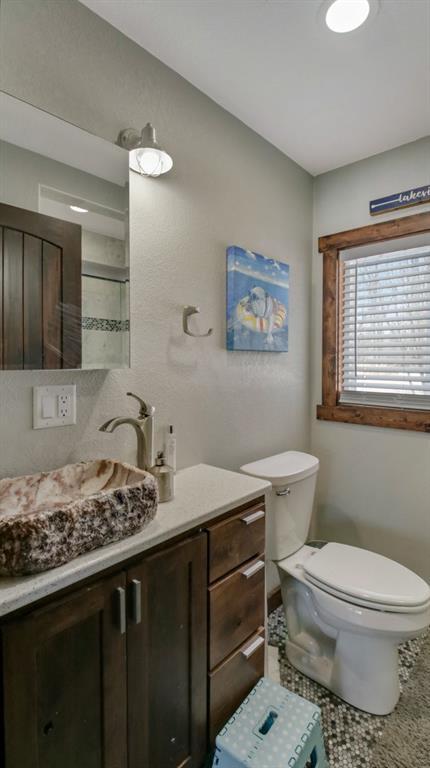 bathroom featuring toilet and vanity