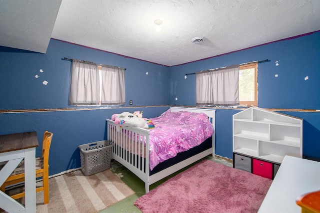 carpeted bedroom with visible vents and a textured ceiling